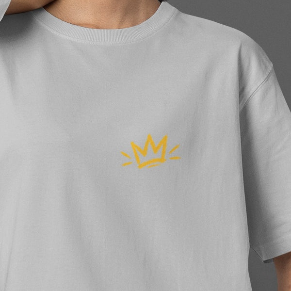 Melange Grey Unfortunately Money Is Everything oversized T-shirt front close-up – small mustard yellow crown print on the left chest
