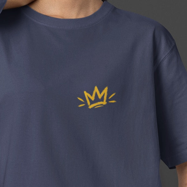 Navy Blue Unfortunately Money Is Everything oversized T-shirt front close-up – small mustard yellow crown print on the left chest