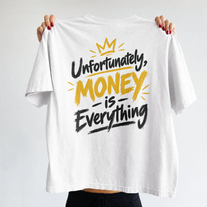 White Unfortunately Money Is Everything oversized T-shirt held up to show the dark back slogan print with MONEY in mustard yellow