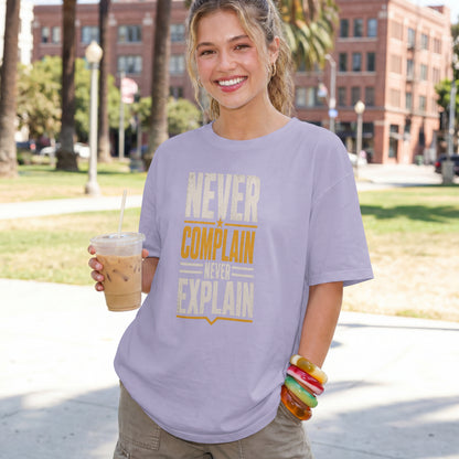 Lavender unisex oversized drop shoulder t-shirt with "Never Complain Never Explain" minimalist print, 100% premium cotton streetwear India.