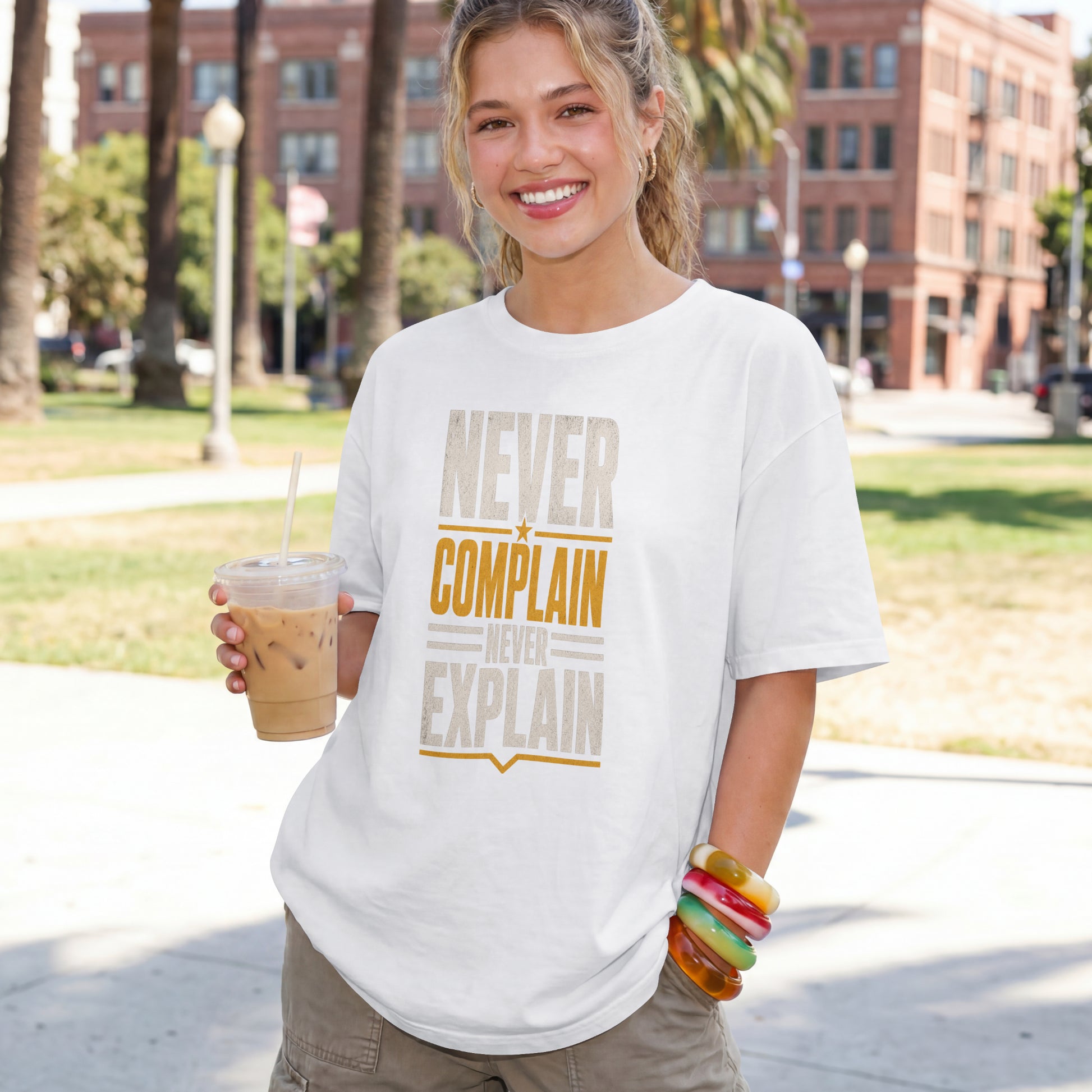 White unisex oversized drop shoulder t-shirt with "Never Complain Never Explain" minimalist print, 100% premium cotton streetwear India.