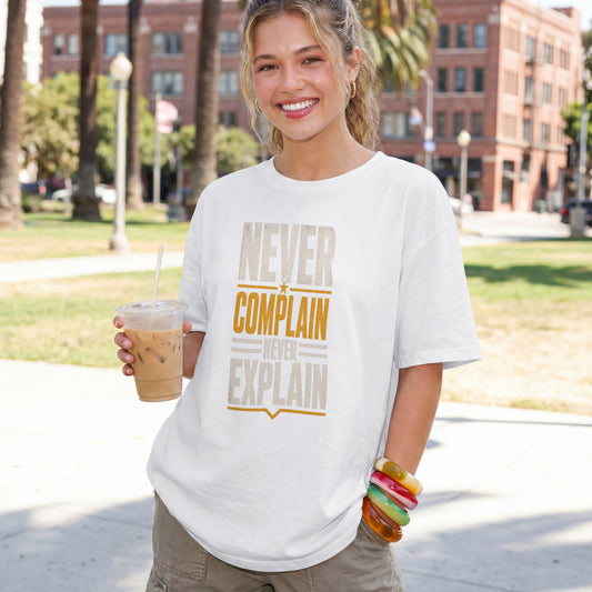 White unisex oversized drop shoulder t-shirt with "Never Complain Never Explain" minimalist print, 100% premium cotton streetwear India.