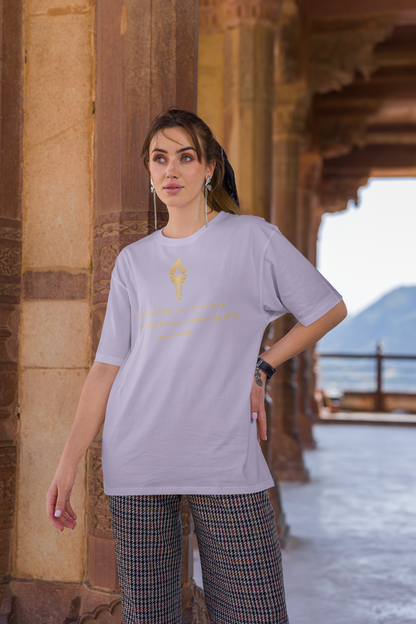 Woman styling a lavender baggy-fit drop-shoulder t-shirt with a gold torch print and inspirational message.