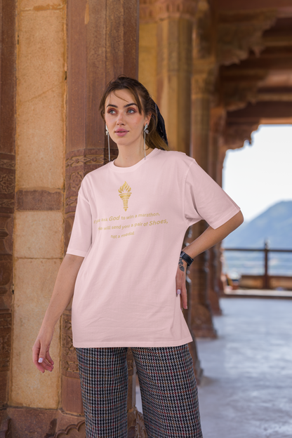 Woman styling a Baby light pink baggy-fit drop-shoulder t-shirt with a gold torch print and inspirational message.