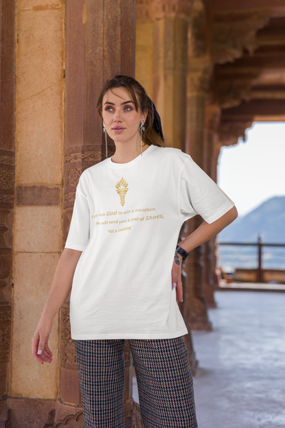 Woman styling a white baggy-fit drop-shoulder t-shirt with a gold torch print and inspirational message.
